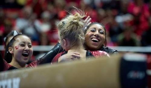 Lennie Mahler  |  The Salt Lake Tribune
Teammates Corrie Lothrop and Kassandra Lopez embrace Georgia Dabritz after her 9.85 beam performance during a super meet at the Huntsman Center on Friday, Jan. 16, 2015.