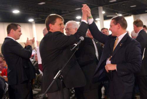 Leah Hogsten  |  The Salt Lake Tribune
Rep. Ken Ivory, R-West Jordan (right) high-fives Rep. Kevin Stratton, R-Orem (left) after Ivory's resolution to demand the federal government transfer control of oil-, timber -and mineral-rich lands to western states
passed at the Utah Republican Party 2014 Nominating Convention at the South Towne Expo Center, Saturday, April 26, 2014.