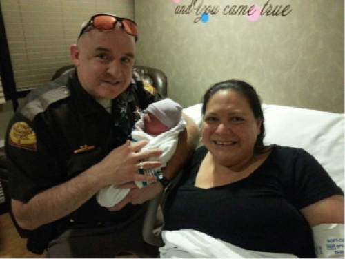 Courtesy  |  Utah Highway Patrol

Utah Highway Patrol Trooper Josh Carr holds Devi Ostler's newborn baby after helping deliver the boy on the side of Interstate 15 on Saturday, Jan. 31, 2015.