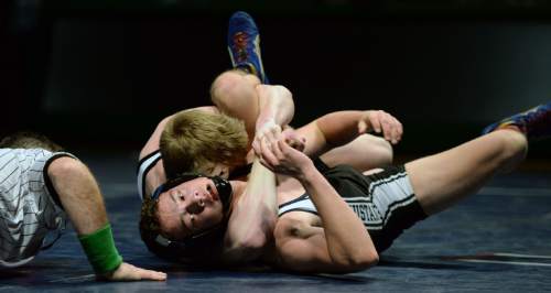 Steve Griffin  |  The Salt Lake Tribune

 Herriman's Logan Jensen, bottom, can't escape the hold of Payson's Jed Loveless during a featured match during the Simplii All-Star Dual, a premier preseason wrestling tournament, at  Utah Valley University in Orem, Tuesday, January 5, 2016.
