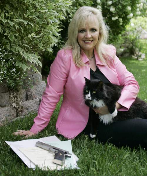 |  Tribune File Photo

Janalee Tobias, a gun and free speech activist, poses with her cat and several appeals she has submitted to the Third District Court, Utah Supreme Court, U.S. Court of Appeals, and the U.S. Supreme Court on May 19, 2006. Tobias feels that more gun control laws are unnecessary and that more focus on family and community development are what will stop crime.