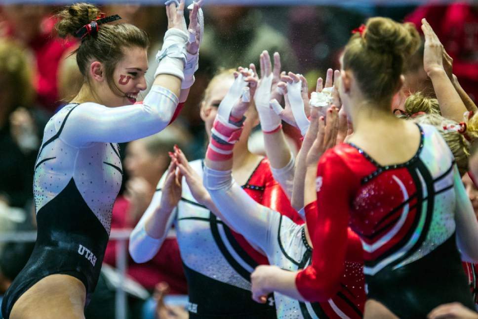Chris Detrick  |  The Salt Lake Tribune
Utah's Baely Rowe celebrates with her teammates after competing on the bars during the gymnastics meet against BYU at the Huntsman Center Friday January 8, 2016.