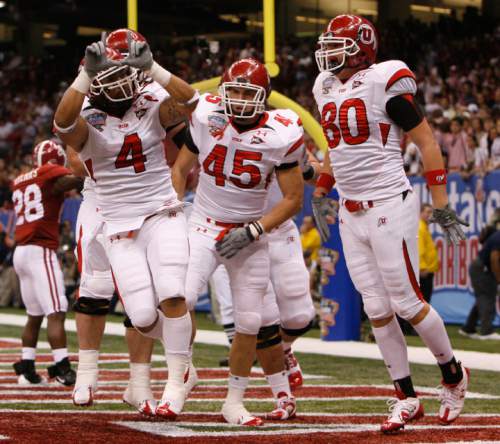 Utah running back Matt Asiata (4), Utah wide receiver Kendrick Moeai (45) or tight end Colt Sampson (45) and Utah tight end Chris Joppru (80) celebrate Asiata's touchdown in the first quarter as the Utes face Alabama in the 75th annual Sugar Bowl in New Orleans, Friday, January 2, 2008.

Scott Sommerdorf/The Salt Lake Tribune