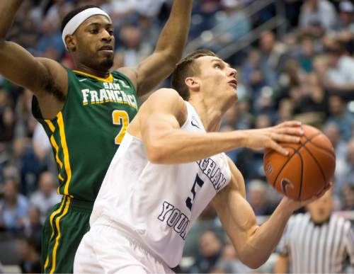 Rick Egan  |  The Salt Lake Tribune

San Francisco Dons guard Tim Derksen Brigham Young Cougars guard Kyle Collinsworth (5) looks for a shot, as he gets by San Francisco Dons forward Uche Ofoegbu (2), in basketball action BYU vs. San Francisco, at the Marriott Center, Saturday, January 9, 2015.