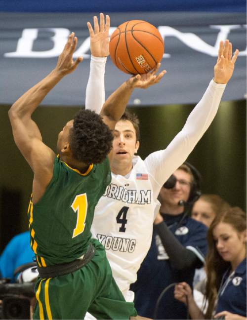 Rick Egan  |  The Salt Lake Tribune

San Francisco Dons guard Devin Watson (1) takes a shot, as Brigham Young Cougars guard Nick Emery (4) defends, in basketball action BYU vs. San Francisco, at the Marriott Center, Saturday, January 9, 2015.