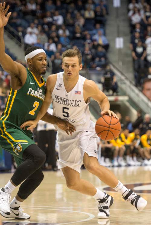 Rick Egan  |  The Salt Lake Tribune

Brigham Young Cougars guard Kyle Collinsworth (5) takes the ball inside as San Francisco Dons forward Uche Ofoegbu (2) defends, in basketball action BYU vs. San Francisco, at the Marriott Center, Saturday, January 9, 2015.