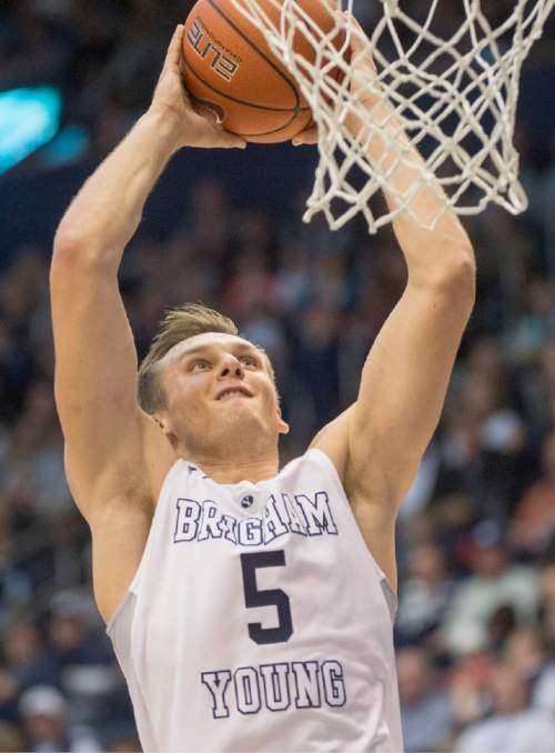 Rick Egan  |  The Salt Lake Tribune

Brigham Young Cougars guard Kyle Collinsworth (5) goes in a dunk, in basketball action BYU vs. San Francisco, at the Marriott Center, Saturday, January 9, 2015.