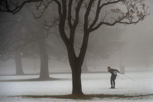 Al Hartmann  |  The Salt Lake Tribune
Cross country skier in Liberty Park moves through the dense fog Thursday morning  Jan 7.
