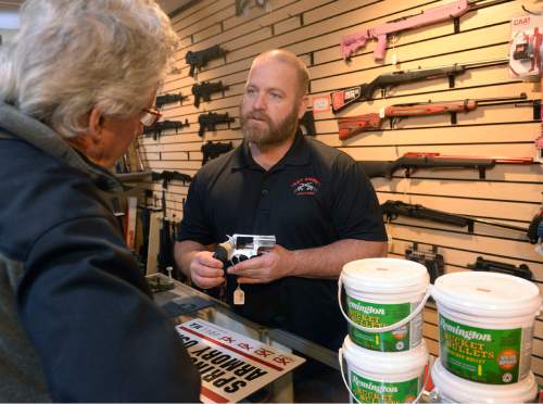 Al Hartmann  |  The Salt Lake Tribune
Stuart Wallin, owner of Get Some Guns and Ammo helps customer with advice on a handgun at the flagship store in Murray Friday Jan. 8.  Gun sales in Utah spiked in 2015, but didn't top the highs in 2012 and 2013. Both spikes appear to be in reaction to terrorist attacks and calls for gun control by President Barack Obama.