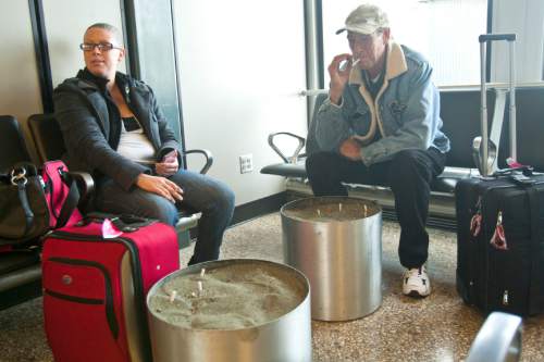 Chris Detrick  |   Tribune file photo
Randall and Shannon Worsham, of California, smoke in the smoking lounge at the Salt Lake City International Airport Tuesday November 20, 2012.