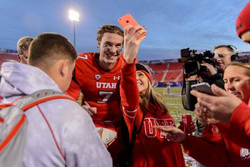 Trent Nelson  |  The Salt Lake Tribune
Utah Utes quarterback Travis Wilson (7) poses for a selfie with a fan after Utah defeated BYU 35-28 in the Royal Purple Las Vegas Bowl, NCAA football at Sam Boyd Stadium in Las Vegas, Saturday December 19, 2015.