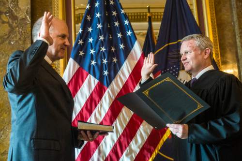 Chris Detrick  |  The Salt Lake Tribune
State Treasurer David Damschen is sworn in by Utah Supreme Court Justice John Pearce in the Gold Room of the Utah State Capitol Wednesday January 13, 2016.