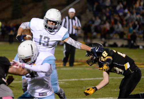 Francisco Kjolseth  |  The Salt Lake Tribune
Sky View's Bryce Mortenson, #13, stiff arms Hunter Mather, #28, of Roy in game action on Thursday, Oct. 23, 2014, at Roy High School.