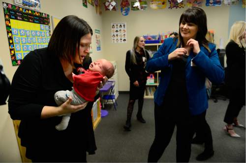 Scott Sommerdorf   |  The Salt Lake Tribune
Alyson Ainscough, left, holds her three-week old son, Augustus Carter as Ashley Alfieri, right, watches in the new child care center at Cornerstone Counseling after a news conference that announced a new medical clinic at VOA's Cornerstone Counseling Center, Thursday, January 14, 2016. The child care center will allow parents to have a safe place to keep their children while they are there seeking care.