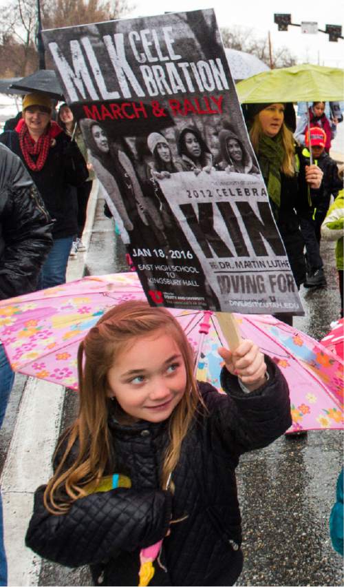 Rick Egan  |  The Salt Lake Tribune

Candice Robinson, 7, holds a sign as she walks along 1300 East, from East High School to University of Utah for the Martin Luther King Jr Day march, Monday, January 18, 2016.