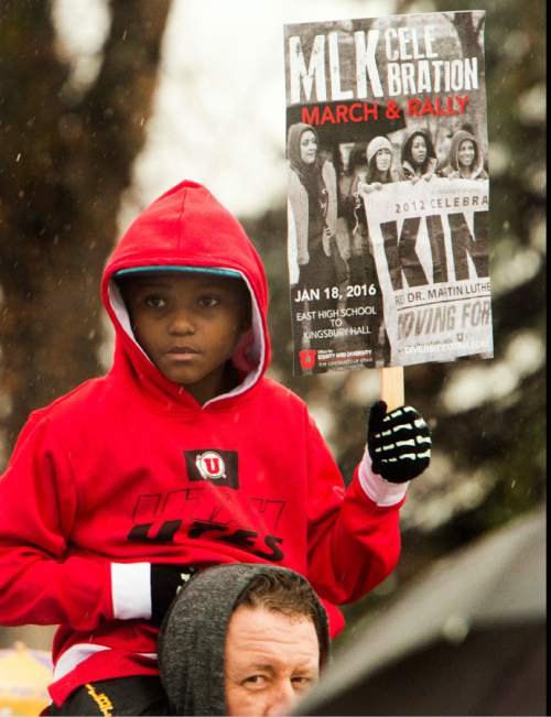 Rick Egan  |  The Salt Lake Tribune

Ten-year-old Christian Gilbert, rides on Marcus Gilbert's shoulders, as they walk along 1300 East, from East High School to University of Utah for the Martin Luther King Jr Day march, Monday, January 18, 2016.