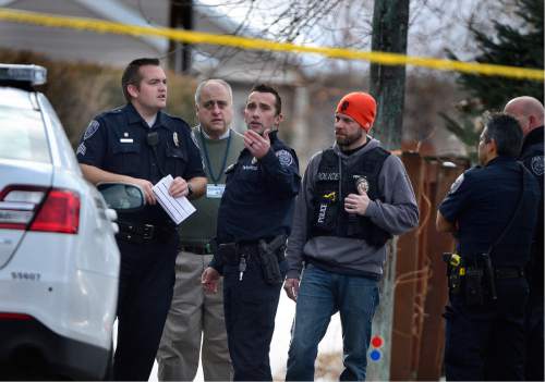 Scott Sommerdorf   |  The Salt Lake Tribune
Police talk at the scene of an officer-involved shooting, in Holladay, Sunday, January 17, 2016.