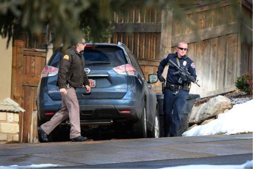 Scott Sommerdorf   |  The Salt Lake Tribune
A Unified Police officer works a search of the neighborhood with a UHP officer. Police at the scene of an officer-involved shooting, in Holladay, Sunday, January 17, 2016.