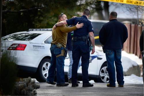 Scott Sommerdorf   |  The Salt Lake Tribune
Police at the scene of an officer-involved shooting, in Holladay, Sunday, January 17, 2016. As new officers arrived at the scene, they would often hug other officers who were working the scene of the shooting.