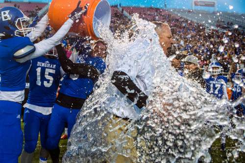 Chris Detrick  |  The Salt Lake Tribune
Assistant Head Coach and Offensive Coordinator John Lambourne gets ice water dumped on him by Bingham's Colton Livingston (5) Michael Green and Kyle Gearig (13) after winning the 5A state championship game at Rice-Eccles Stadium Friday November 21, 2014. Bingham defeated American Fork 20-3.