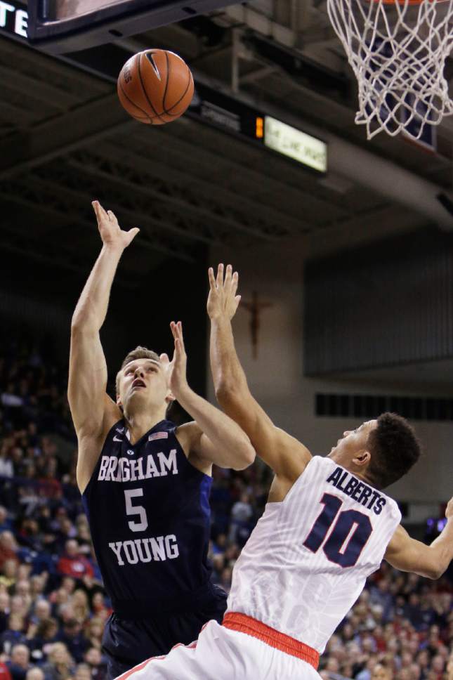 BYU's Kyle Collinsworth (5) shoots against Gonzaga's Bryan Alberts (10) during the first half of an NCAA college basketball game, Thursday, Jan. 14, 2016, in Spokane, Wash. (AP Photo/Young Kwak)