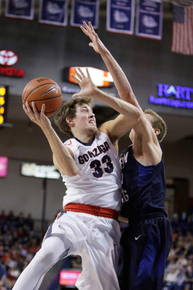 Gonzaga's Kyle Wiltjer (33) shoots against BYU's Kyle Davis during the first half of an NCAA college basketball game, Thursday, Jan. 14, 2016, in Spokane, Wash. (AP Photo/Young Kwak)