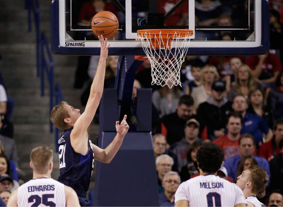 BYU's Kyle Davis (21) shoots in front of Gonzaga's Ryan Edwards, left, Domantas Sabonis, right, and Silas Melson during the first half of an NCAA college basketball game, Thursday, Jan. 14, 2016, in Spokane, Wash. (AP Photo/Young Kwak)