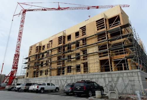 Francisco Kjolseth | The Salt Lake Tribune
A new apartment building is constructed West of Pioneer Park in Downtown Salt Lake City. A poll on the Utah economy is tied to new report released on Tuesday.