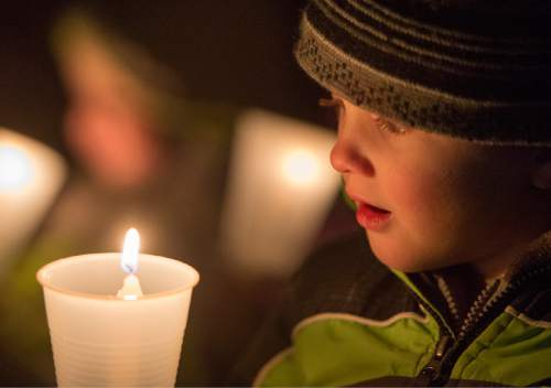 Rick Egan  |  The Salt Lake Tribune

Nixon Judson, 5, holds candle during a vigil for Unified Police Officer, Doug Barney, at the Holladay City Hall, Wednesday, January 20, 2016.