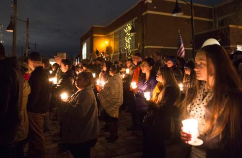 Rick Egan  |  The Salt Lake Tribune

Supporters hold candles during a vigil for Doug Barney, hosted by Holladay City and the Unified Police Department officers of the Holladay Precinct and sponsored by the Salt Lake Valley Law Enforcement Association, at the  Holladay City Hall, Wednesday, January 20, 2016.