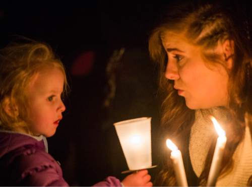 Rick Egan  |  The Salt Lake Tribune

Mayzie Blake, 2, and Ashley Blake, Saratoga Springs, hold candles at a vigil for Unified police officer Doug Barney, at the Holladay City Hall, Wednesday, January 20, 2016.