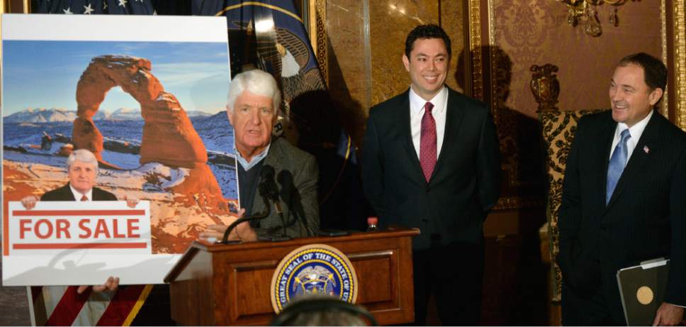 Al Hartmann  |  The Salt Lake Tribune
Utah Congressman Rob Bishop shows a poster criticising his views of federal land use as Congressman Jason Chaffetz and Governor Gary Herbert chuckle.  Bishop said that it was an old photo of him 60 lbs. heavier and that a new photo should be used. The three then unveield a "discussion draft" of their Public Lands Initiative bill affecting 18 million acres in seven eastern Utah counties at the  Capitol Tuesday Jan 20.  Bishop intends on introducing the bill in congress in the next few weeks.