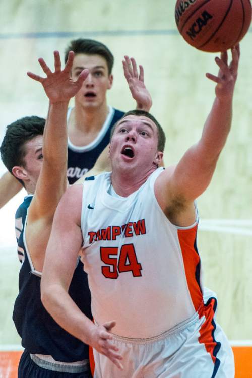 Chris Detrick  |  The Salt Lake Tribune
Timpview's Aj Bollinger (54) drives past Corner Canyon's Brayden Johnson (13) and Corner Canyon's Kyle Gwilliam (32) during the game at Timpview High School Friday January 22, 2016.