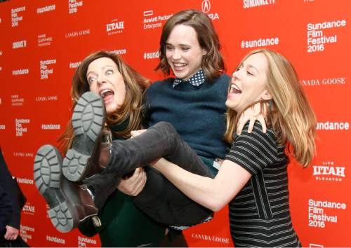 Actress Allison Janney, left, and director and writer Sian Heder, right, pick up and swing actress Ellen Page, center, as they pose at the premiere of "Tallulah" during the 2016 Sundance Film Festival on Saturday, Jan. 23, 2016, in Park City, Utah. (Photo by Danny Moloshok/Invision/AP)