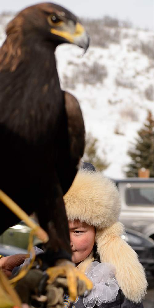 Trent Nelson  |  The Salt Lake Tribune
Aisholpan Nurgaiv, a 15-year-old Mongolian girl who is the first female in 2,000 years to learn to be a eagle hunter in her culture, was given a Comanche blessing by Waha Thuweeka, at the Kimball Art Center in Park City, on Friday, Jan. 22, 2016. Nurgaiv is the subject of the Sundance documentary "The Eagle Huntress."