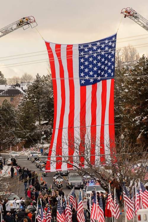 Trent Nelson  |  The Salt Lake Tribune
A long motorcade makes its way to the Orem City Cemetery Monday January 25, 2016, for the graveside service for Officer Douglas Scott Barney, who was fatally shot by Corey Lee Henderson following a car crash in Holladay on January 17.