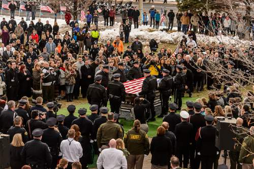 Trent Nelson  |  The Salt Lake Tribune
Officers fold a flag at the graveside service for Officer Douglas Scott Barney, at the Orem Cemetery, Monday January 25, 2016.