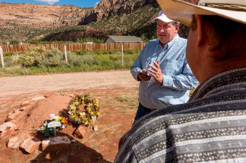 Trent Nelson  |  The Salt Lake Tribune

Dowayne Barlow and Isaac Wyler stand over Walter Steed's grave at the Isaac W Carling Memorial Park Cemetery in Colorado City, Arizona, Wednesday September 16, 2015.