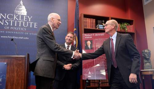 Al Hartmann  |  The Salt Lake Tribune
Former Utah Senator Bob Bennett, left, shakes hands with Jim HInckley, Chairman of the Hinckely Institute at the University of Utah Wednesday Jan. 27 at the University of Utah after being inducted into the Hinckley Insitute Hall of Fame.  Director Jason Perry, center.
