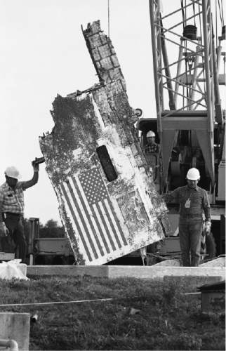 James Neihouse  |  Associated Press file photo
Workmen at Cape Canaveral Air Force Station store debris recovered from the Space Shuttle Challenger accident Jan. 20, 1987 -- nearly a year after the fatal explosion. The section being lowered into the unused Minuteman missile silo is part of the left side of the orbiter.