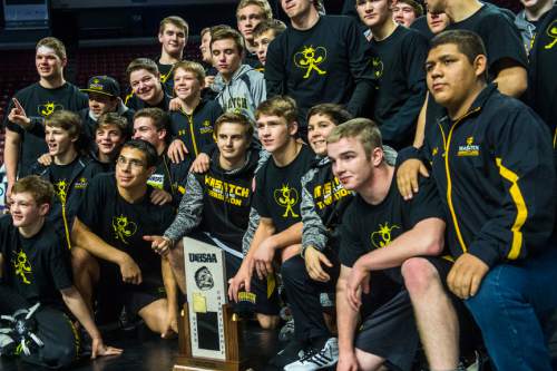 Chris Detrick  |  The Salt Lake Tribune
Members of the Wasatch wrestling team pose for pictures with 4A championship trophy State Duals at the Maverik Center Thursday January 28, 2016.