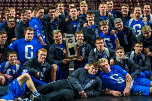 Chris Detrick  |  The Salt Lake Tribune
Members of the Pleasant Grove' wrestling team pose for pictures with 5A championship trophy State Duals at the Maverik Center Thursday January 28, 2016.