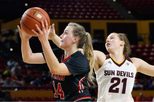 Utah's Paige Crozon (14) goes in to score as she drives past Arizona State's Sophie Brunner (21) during the first half of an NCAA college basketball game Sunday, Jan. 17, 2016, in Tempe, Ariz. (AP Photo/Ross D. Franklin)