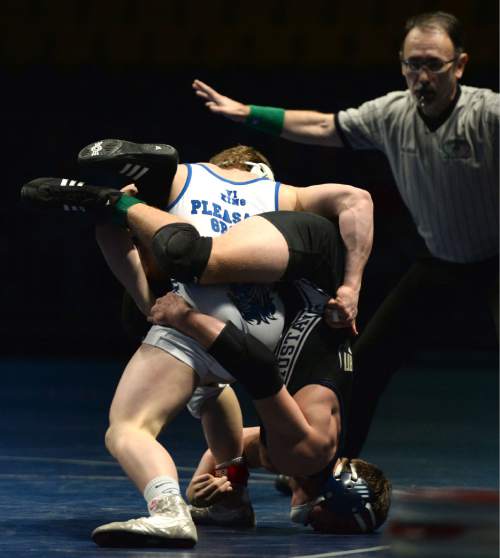 Steve Griffin  |  The Salt Lake Tribune

Pleasant Grove's Ben Anderson stands Herriman's Jaron Jensen on his head as Jensen hangs on during a featured match in the Simplii All-Star Dual, a premier preseason wrestling tournament, at Utah Valley University in Orem, Tuesday, January 5, 2016.