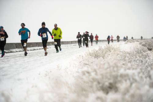Chris Detrick  |  The Salt Lake Tribune
Runners brave a snowstorm while participating in the Salt Lake City Track Club's 5k at the Saltair in Magna Saturday January 30, 2016. It was the first race in the 3-race series, which will conclude with a 15k on Feb 27, 2016 at the Saltair.