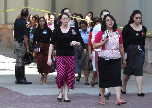 Rick Egan  | The Salt Lake Tribune 

Sister missionaries are evacuated from Temple Square to be checked out by emergency personal, after a gas leak was detected in the South Visitors Center at Temple Square, Thursday, August 22, 2013.