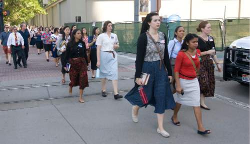 Rick Egan  | The Salt Lake Tribune 

Sister missionaries are evacuated from Temple Square to be checked out by emergency personal, after a gas leak was detected in the South Visitors Center at Temple Square, Thursday, August 22, 2013.