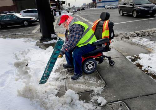 Scott Sommerdorf   |  The Salt Lake Tribune
Donna Beard shovels snow and ice from her wheelchair at the intersection of 2100s, and State Street as she works as a volunteer, Sunday, January 31, 2016.