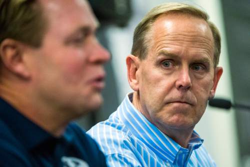 Chris Detrick  |  The Salt Lake Tribune
Athletic Director Tom Holmoe listens as Cougar football head coach Bronco Mendenhall speaks during a press conference at Brigham Young University Friday December 4, 2015.  Mendenhall signed a five-year contract with the University of Virginia that will pay him $3.25 million annually, estimated to be more than three times the money he makes coaching BYU.