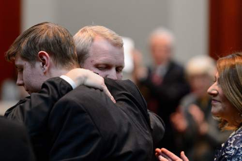 Trent Nelson  |  The Salt Lake Tribune
John A. Pearce embraces his son Ben at his Investiture Ceremony as a justice for the Utah Supreme Court, in Salt Lake City, Friday January 29, 2016. At right is Pearce's wife, Jennifer Napier-Pearce.